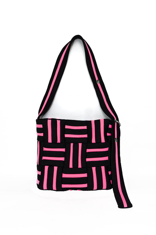 Black and pink geometric patterned bag on a white background